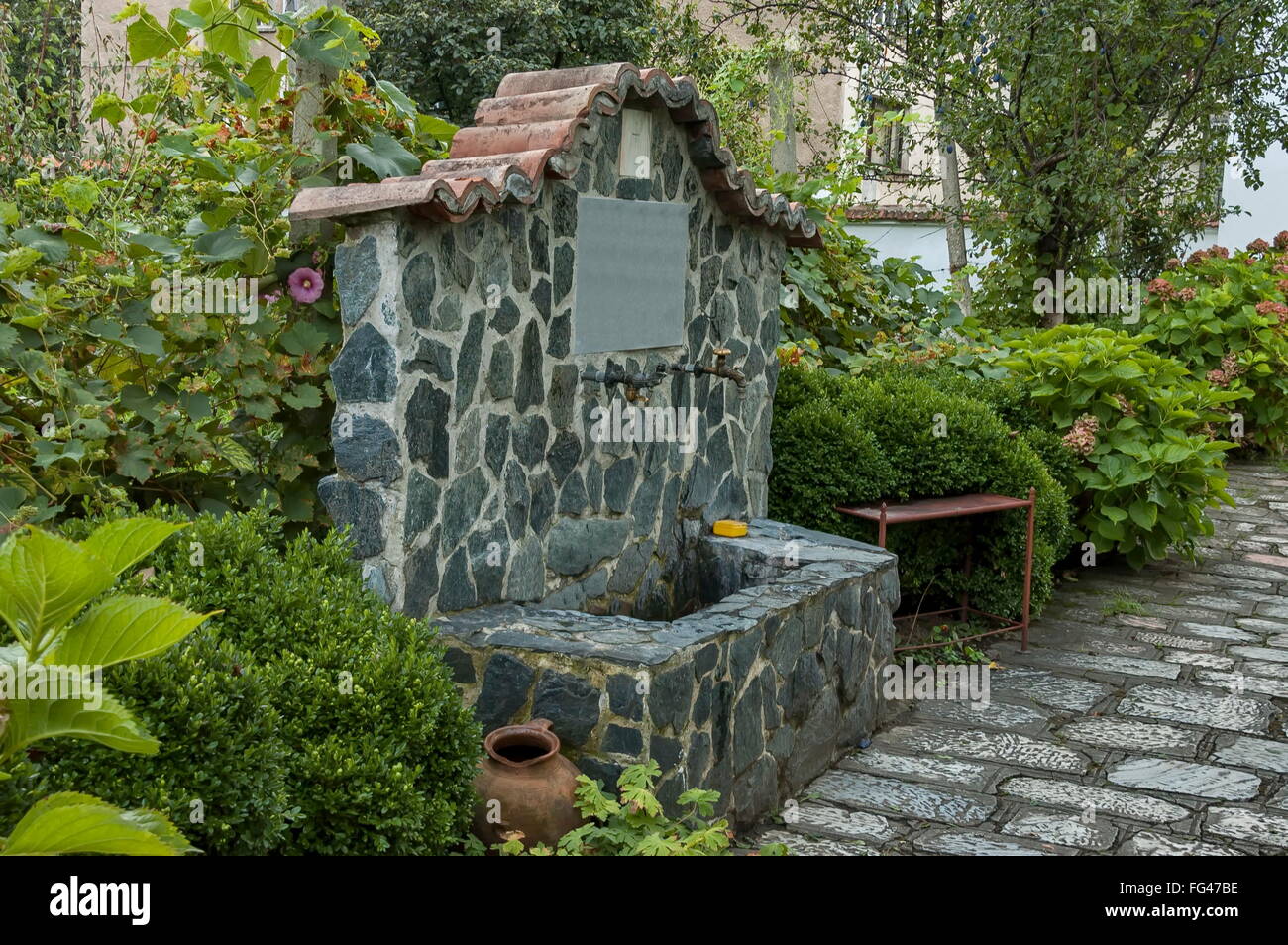 Spring water fountain at Church Virgin Birth in Berkovitsa, Bulgaria Stock Photo