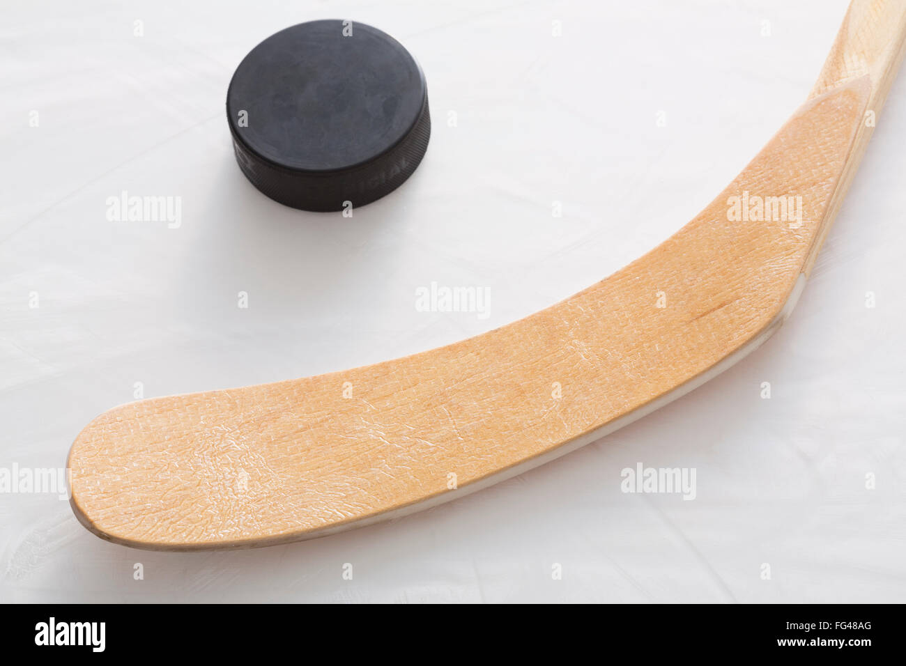 Ice hockey stick and puck Stock Photo
