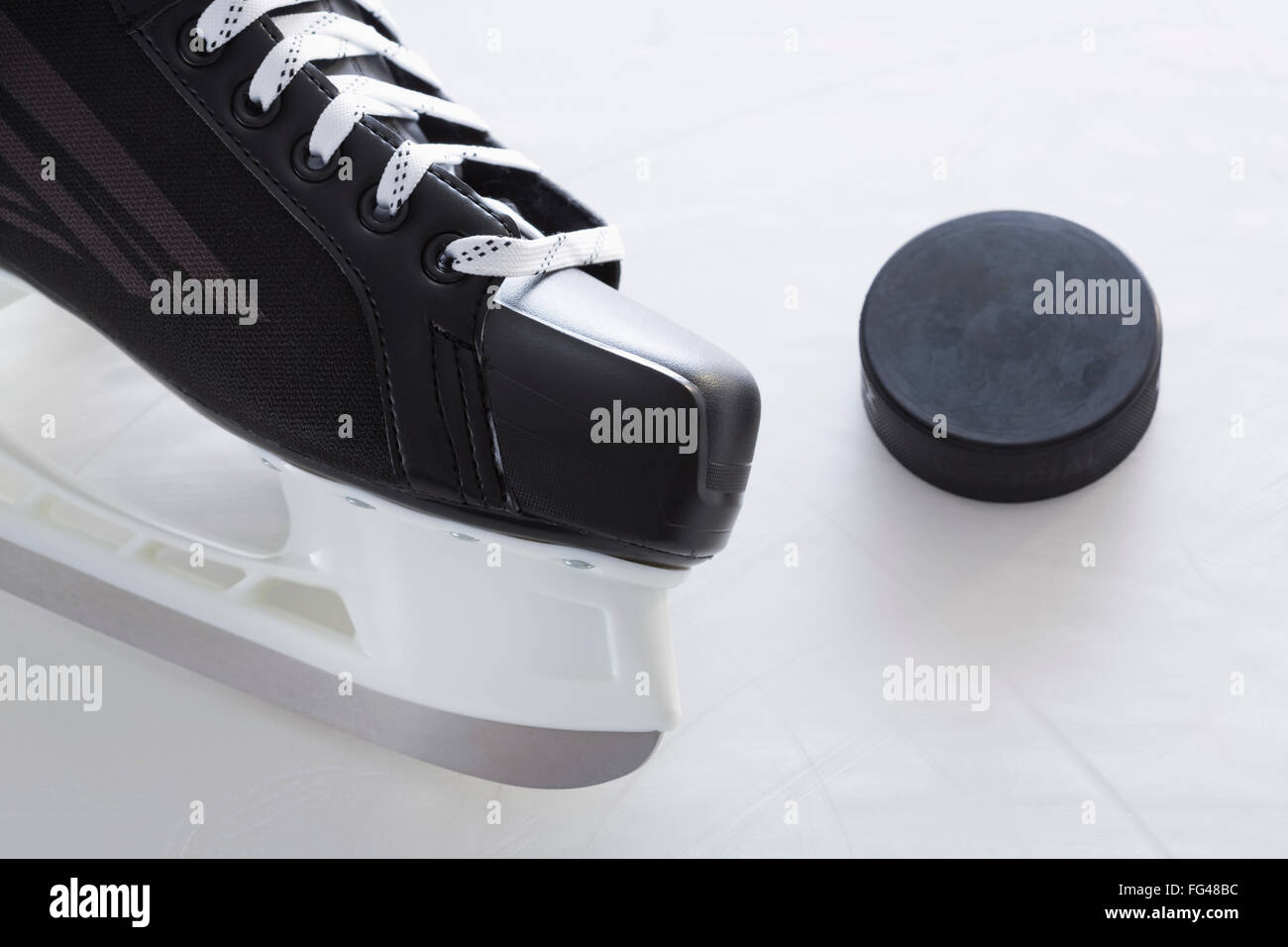 Ice skate and hockey puck Stock Photo