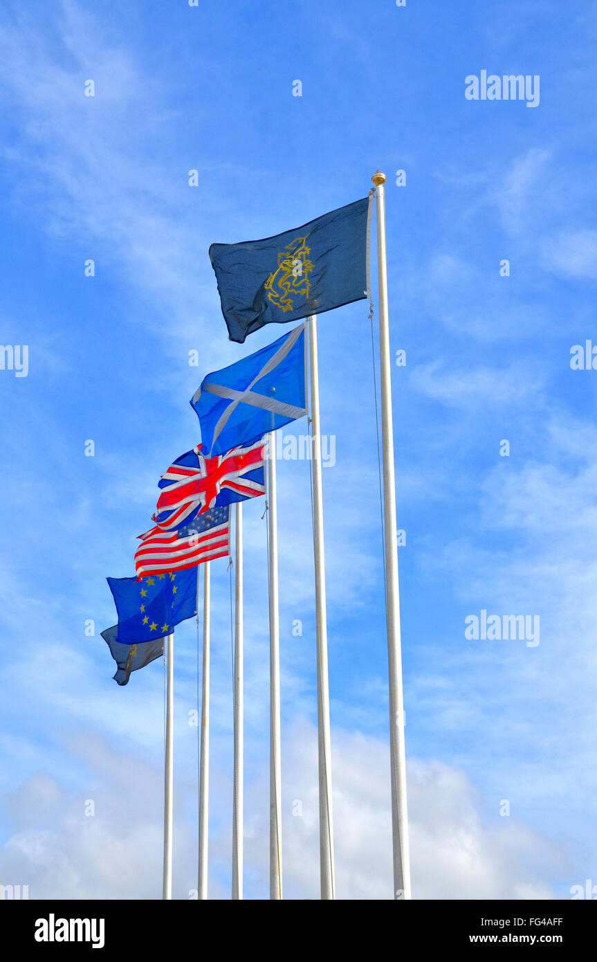Flags of Great Britain, Scotland, EU, and USA flown in a row of flag poles.  Lion Rampart is also included. Stock Photo