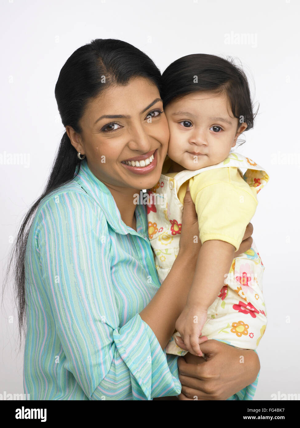 Indian mother and baby girl touching cheeks MR#702O&702L Stock Photo
