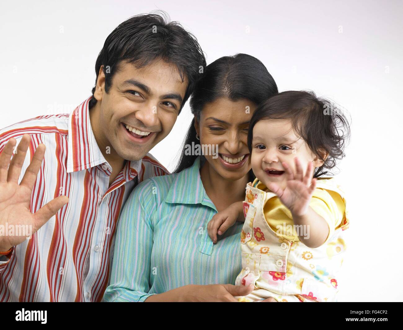 Indian parent with baby girl doing tata MR#702O,702A,702L Stock Photo