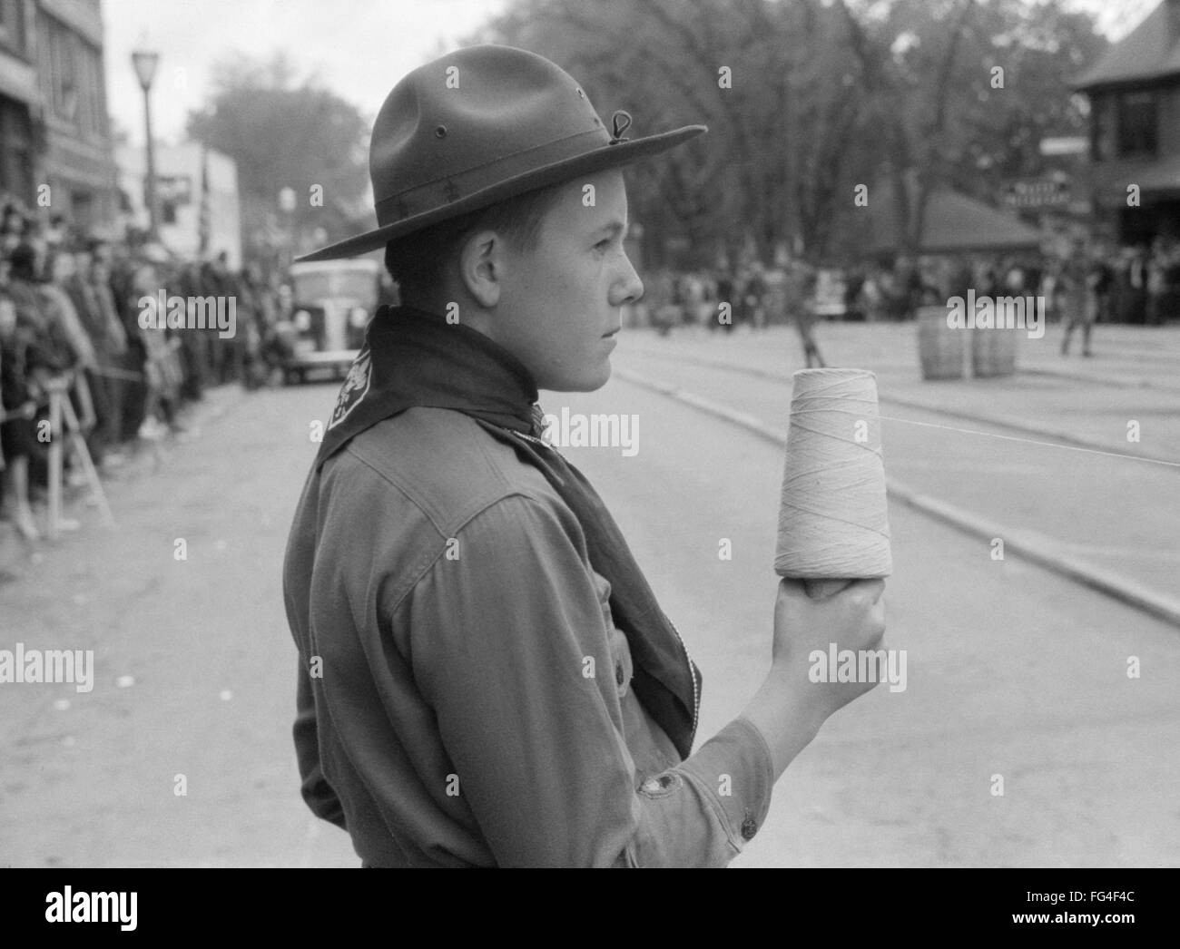 MAINE BOY SCOUT, 1940. /nA Boy Scout holding string at the finish line of a barrel rolling