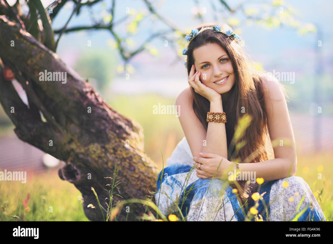 Smiling and joyful woman in spring meadow. Nature and harmony Stock Photo
