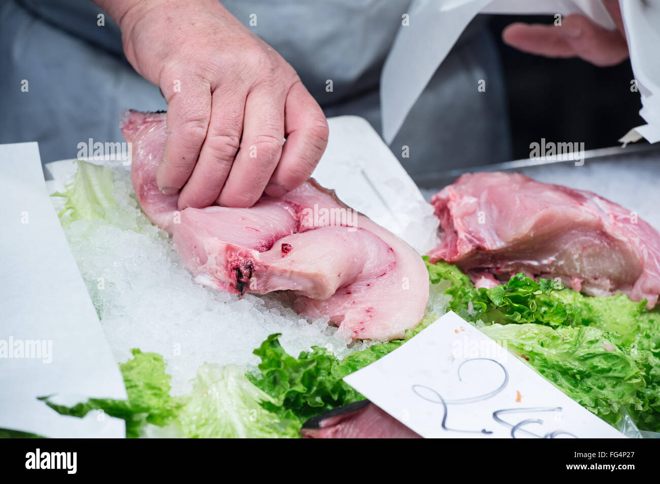 fisherman take slice of swordfish to the fish market Stock Photo