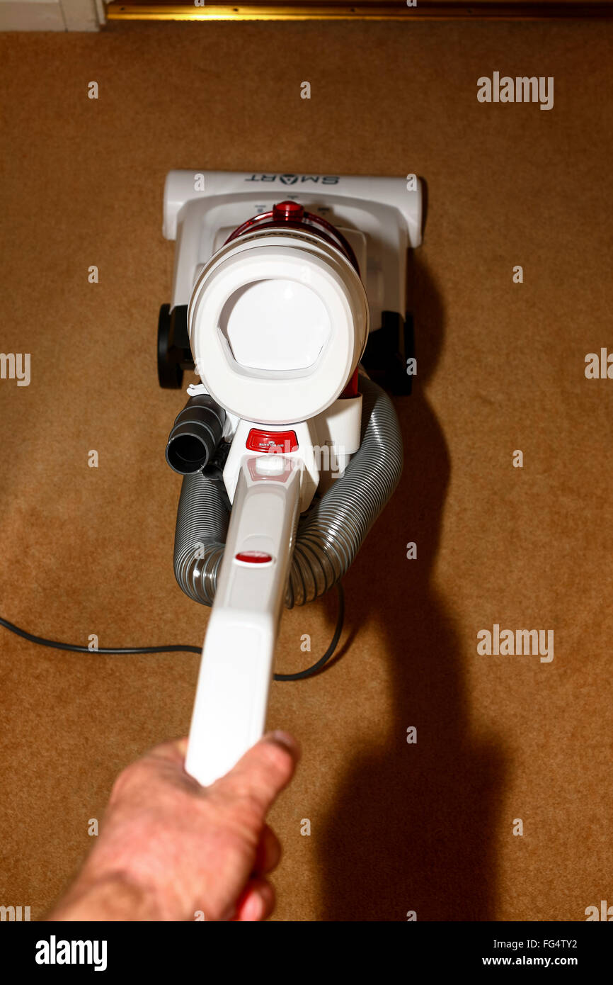 Using a Hoover smart vacuum cleaner to clean a carpet Stock Photo Alamy