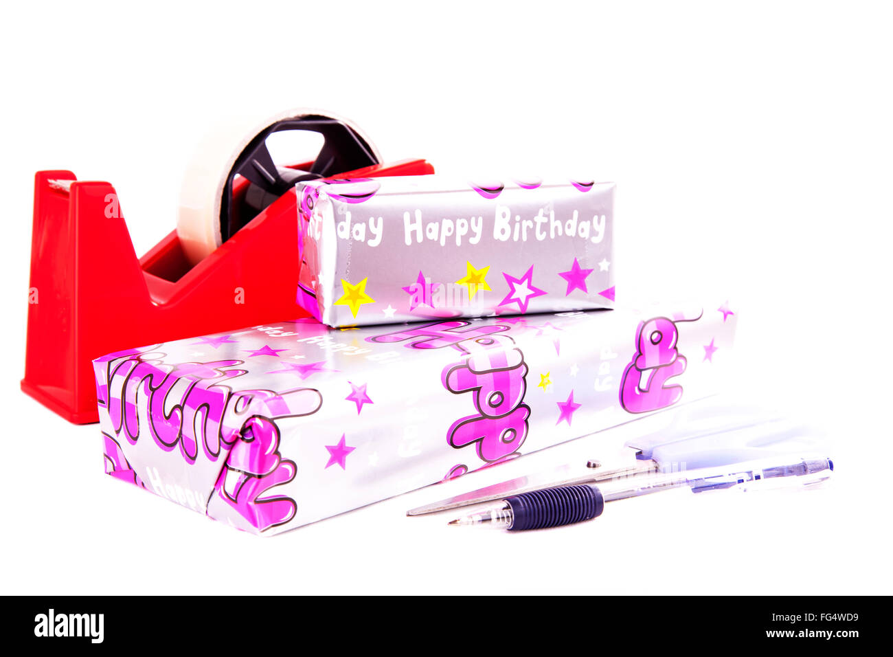 Wrapping birthday presents present gift gifts paper wrapped pen scissors sellotape Cut out cutout isolated white background Stock Photo