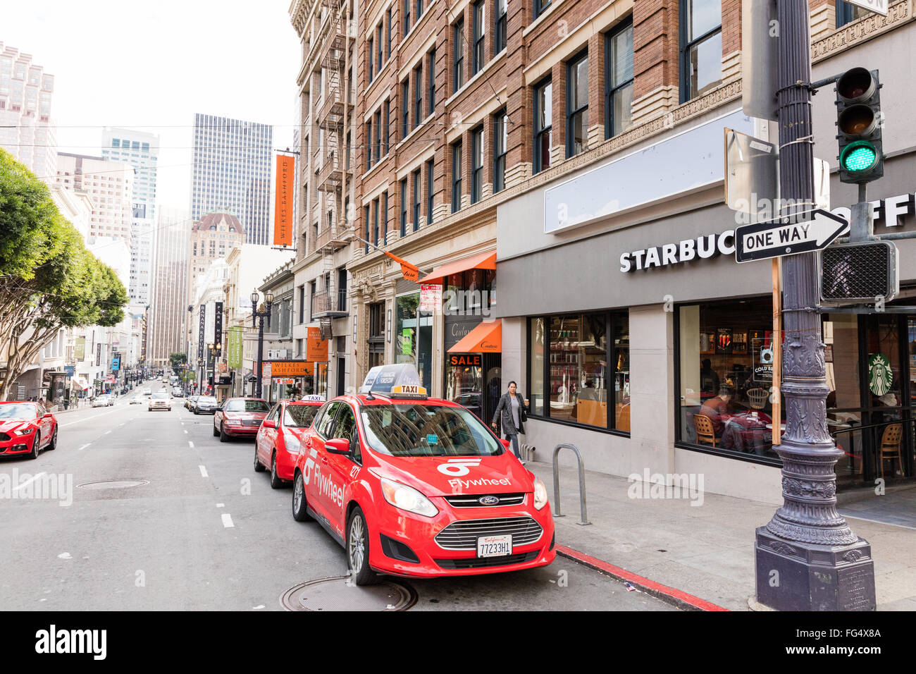 Flywheel red taxi cars parked on the street in San Francisco