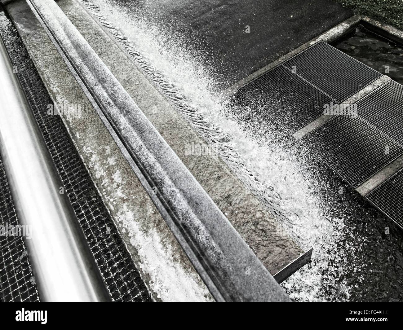 High Angle View Of Frozen Drainage By Sidewalk Stock Photo