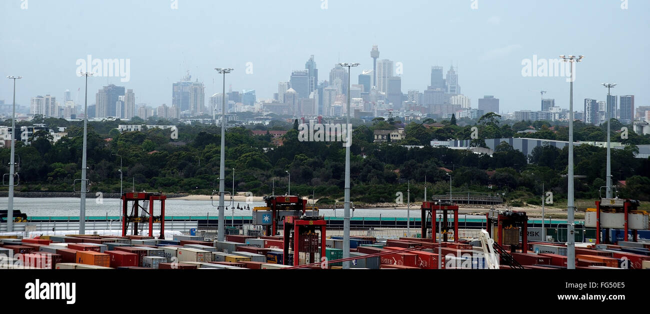 Foreground Sydney port area cranes and containers background stunning city distant view with tall architectural buildings Stock Photo