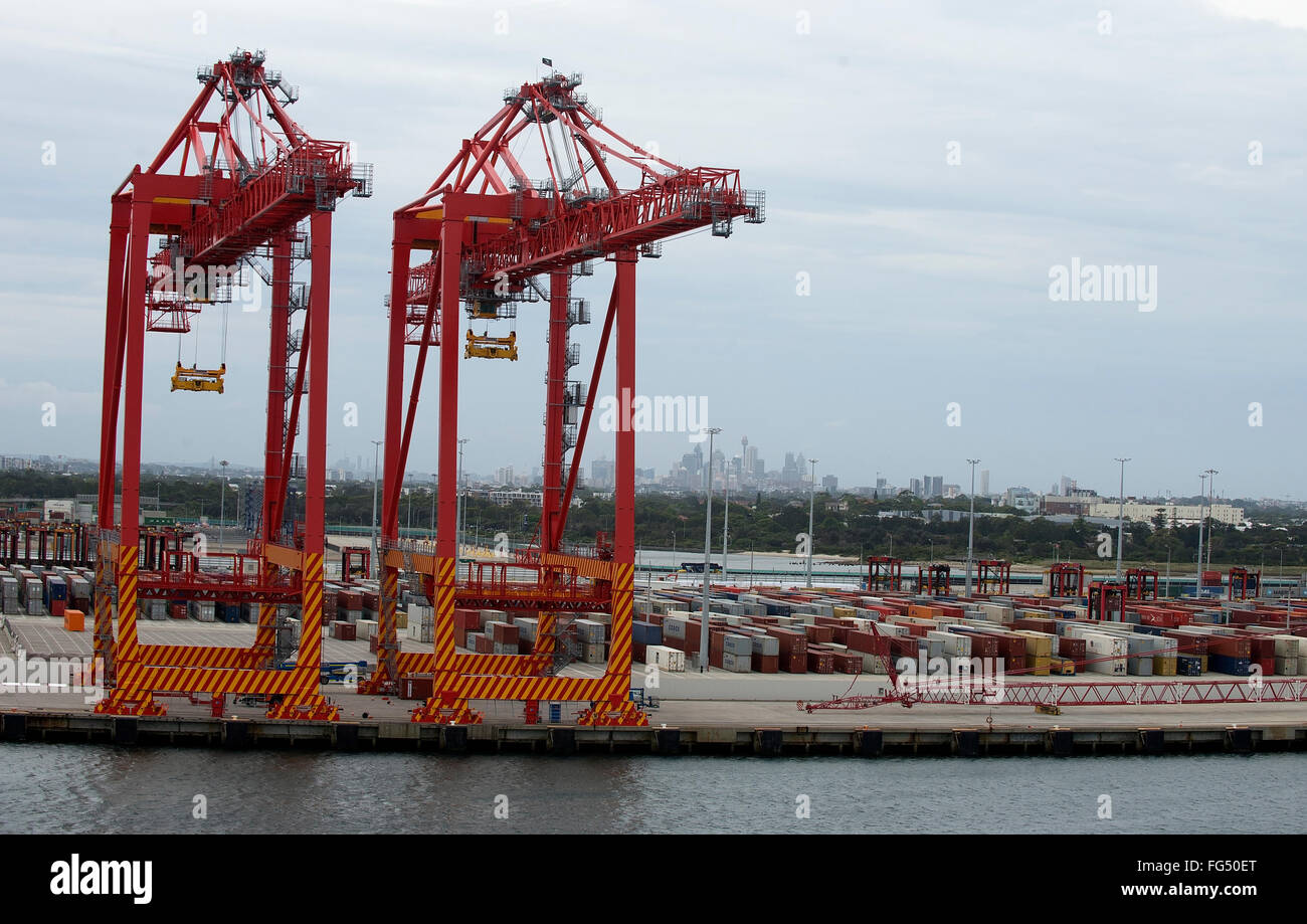 Cranes transporting single containers into the shipping dock in Sydney Port, Australia. Stock Photo