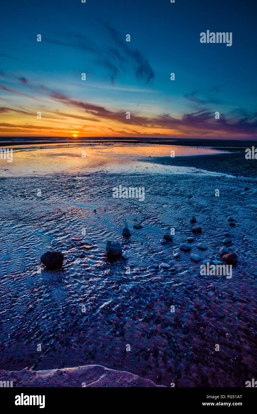 Amazing sunset on the D River Beach in Lincoln City Oregon, home of the world's shortest river that flows into the ocean. Stock Photo