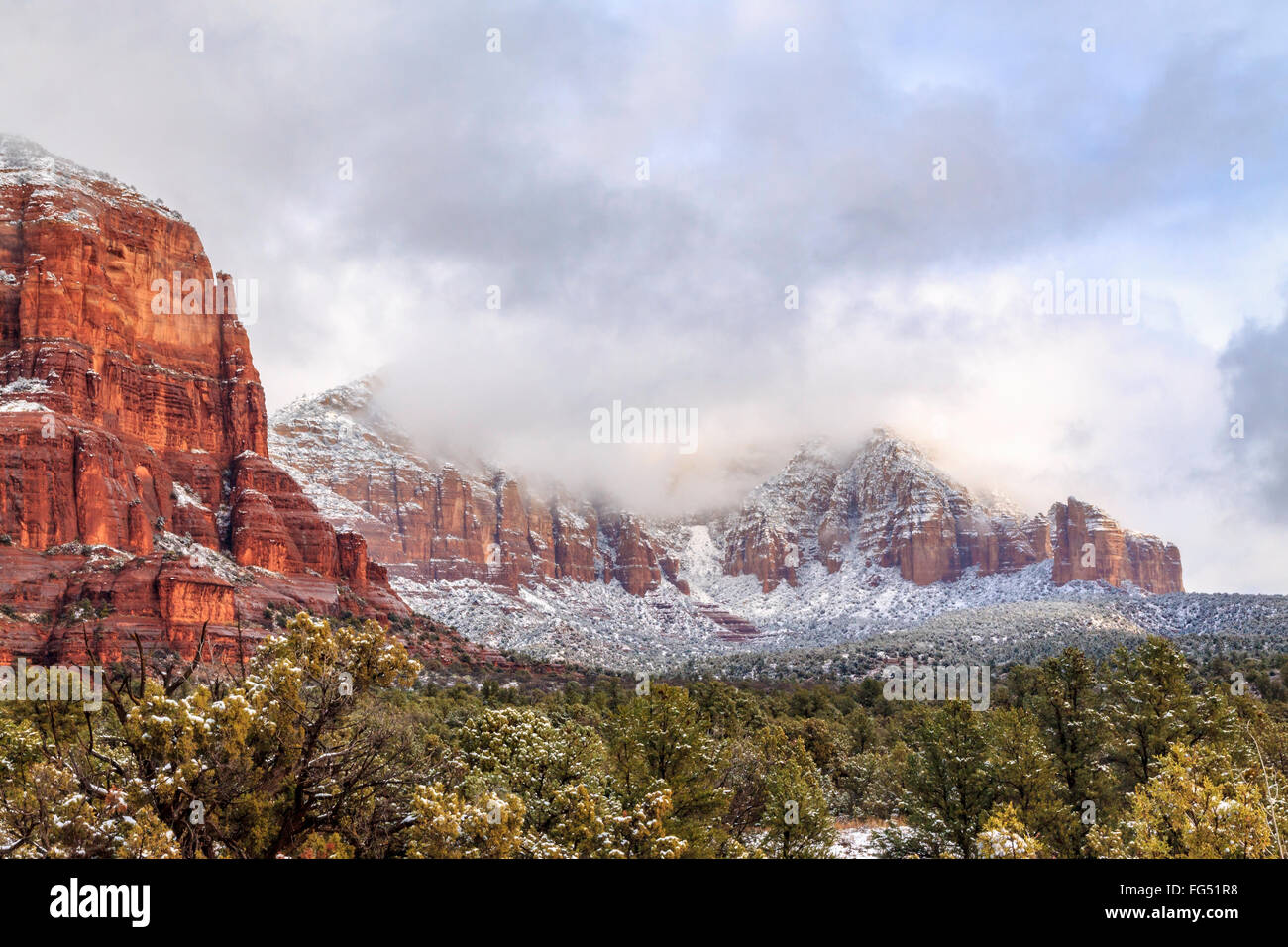 Courthouse Rock & Lee Mountain in Sedona, after a passing snowstorm. Lee Mountain still enveloped in the retreating storm clouds Stock Photo