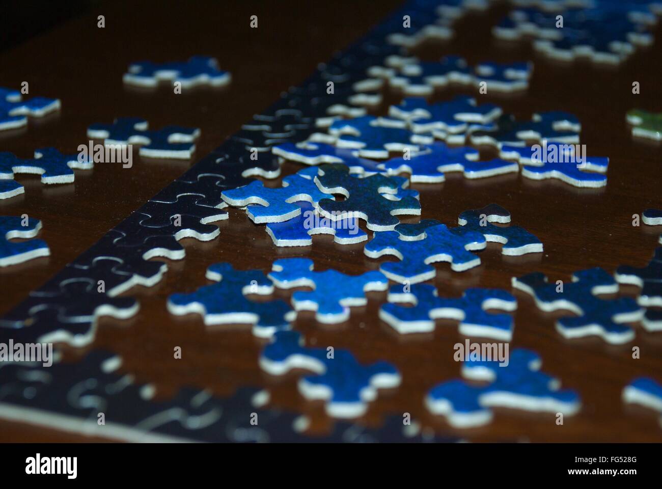 Blue puzzle pieces on dark background Stock Photo - Alamy