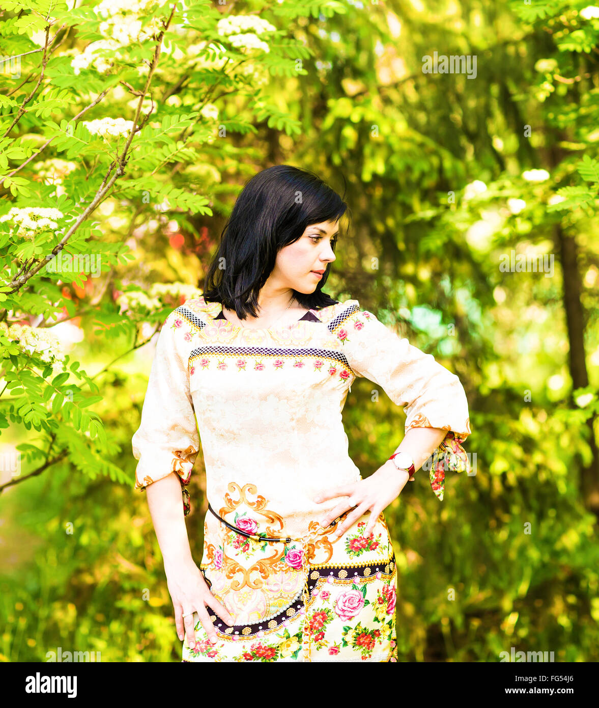 Beautiful woman standing in a park in spring or summer Stock Photo - Alamy