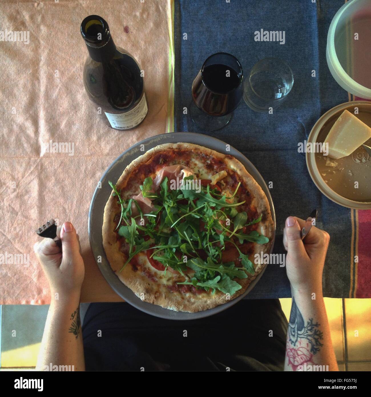 Cropped Image Of Hand With Pizza And Wine On Table Stock Photo
