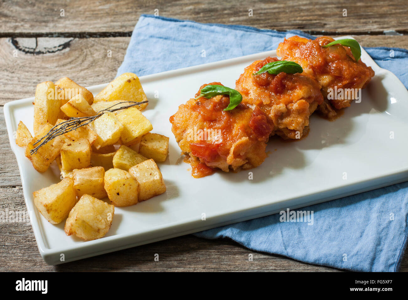Cod Fish With Tomato Sauce And Deep Fried Potato On Tray Stock Photo Alamy