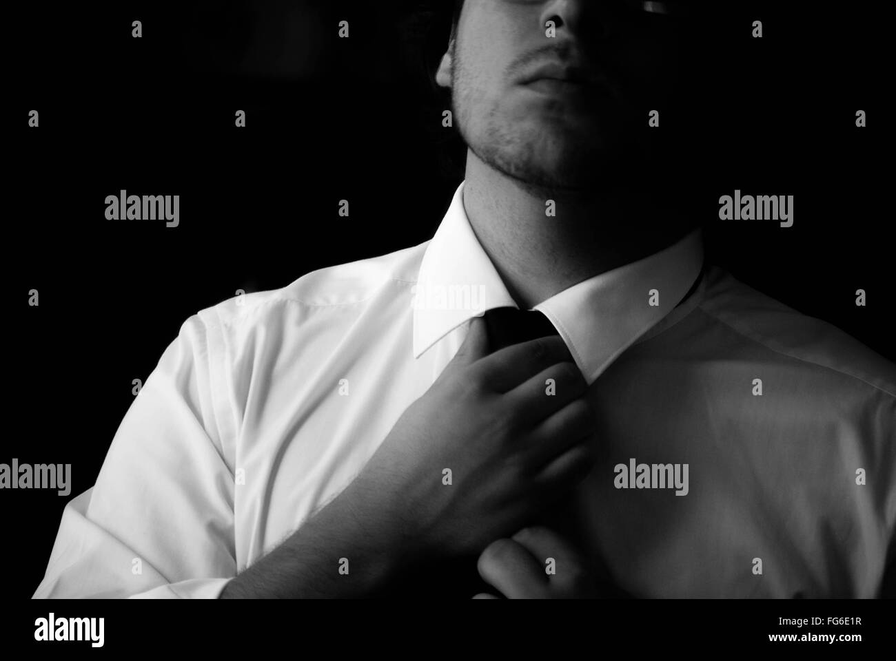 Adjusting tie hi-res stock photography and images - Alamy