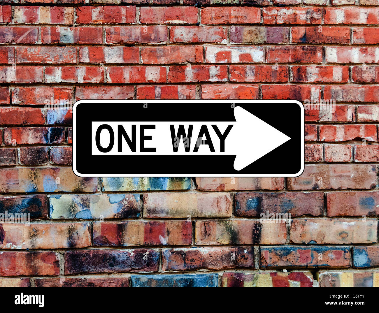 One Way Sign on Brick Wall Stock Photo