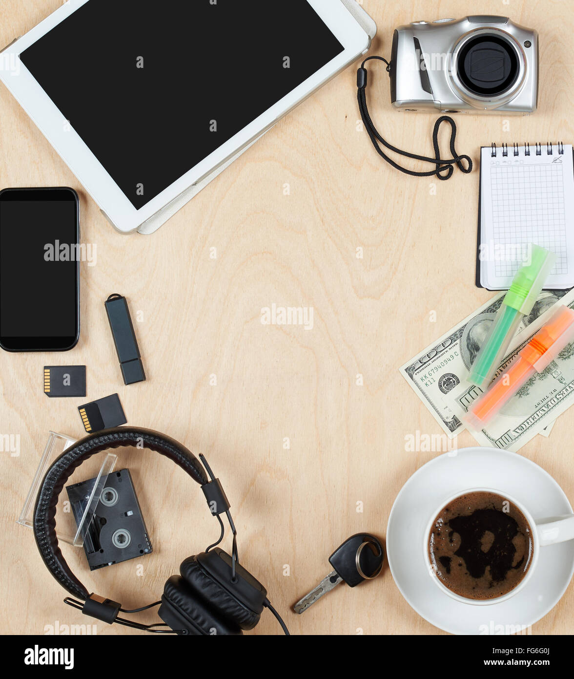 Flat lay of personal stuff, tablet computer,cards, coffee, money, camera photo and other. Flat design and top view on desk as fr Stock Photo