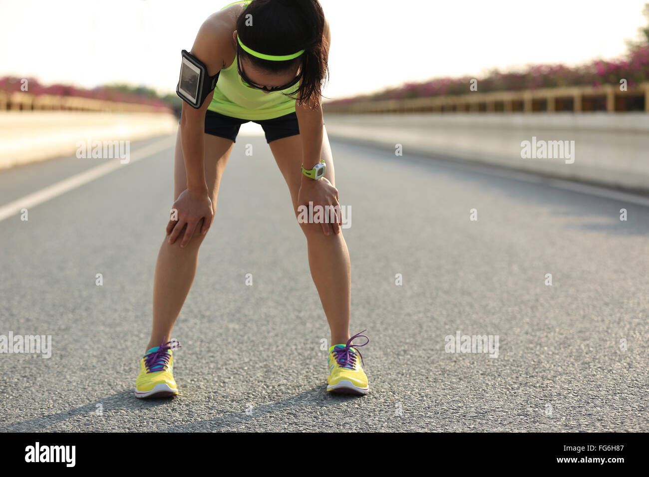 tired woman runner taking a rest after running hard on city road Stock ...