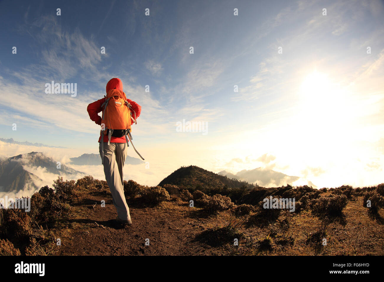 young woman backpacker hiking on mountain peak Stock Photo - Alamy