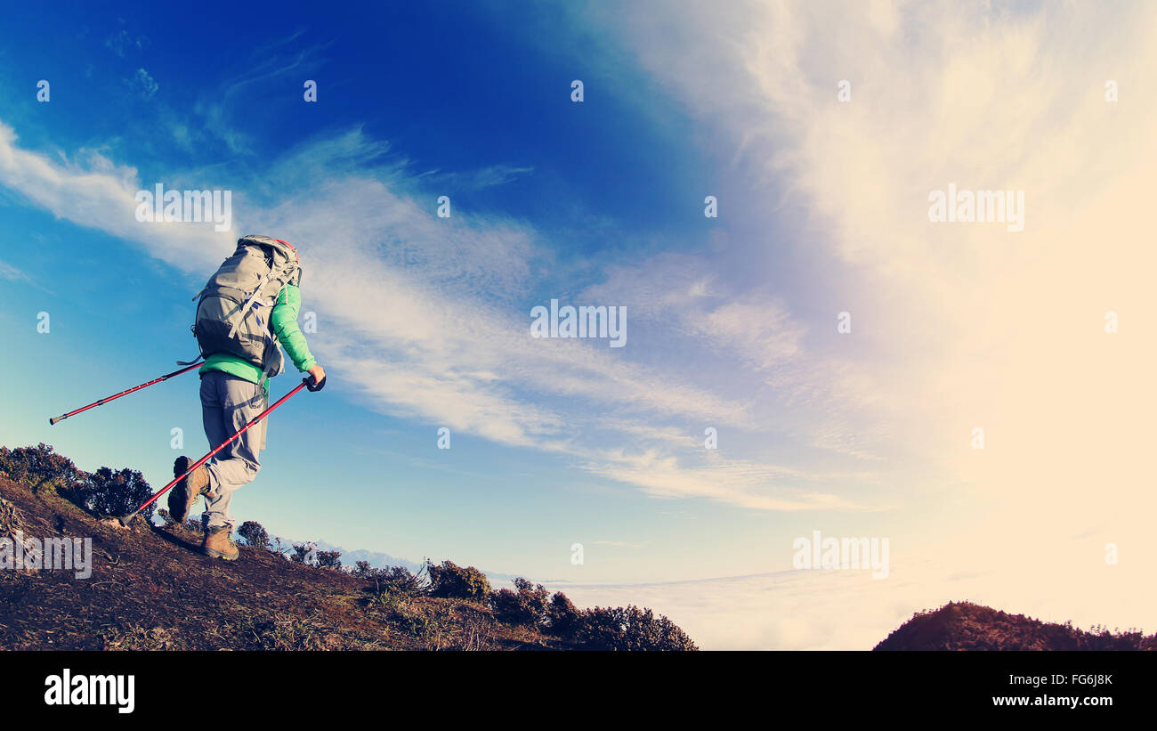 young woman backpacker hiking on mountain peak Stock Photo - Alamy