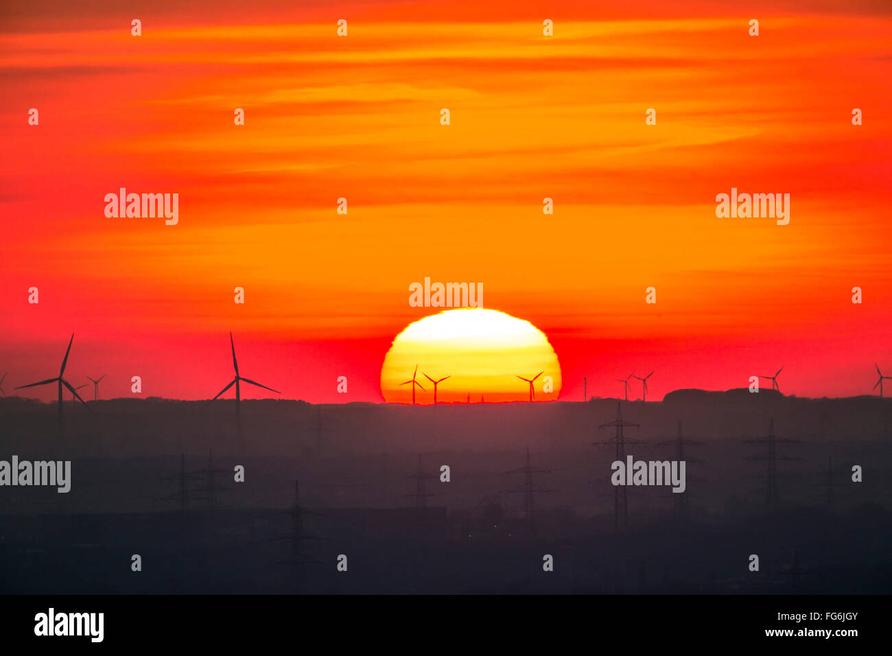 Sunset in the Ruhr area and Lower Rhine area, Germany, wind parks, wind energy, wind power  plants, power lines, power poles Stock Photo