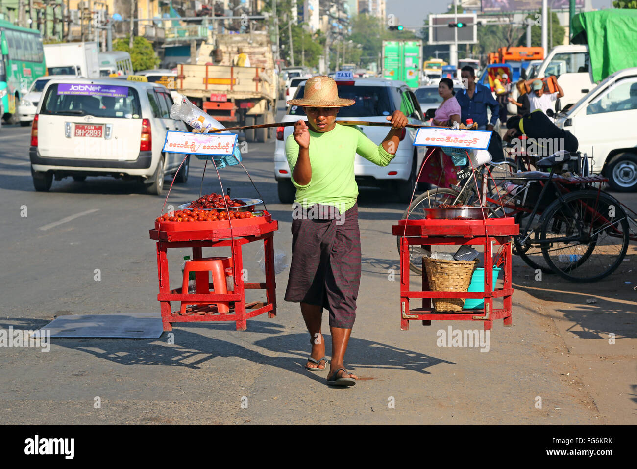 Street seller carrying wares on his shoulders, Yangon, Myanmar Stock Photo