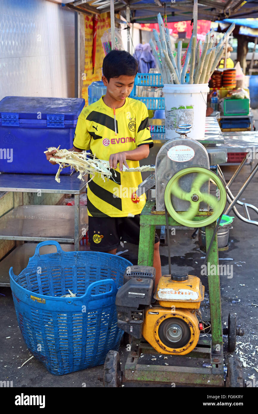 Boy making Durian juice in the street by squeezing the fruit, Yangon, Myanmar Stock Photo