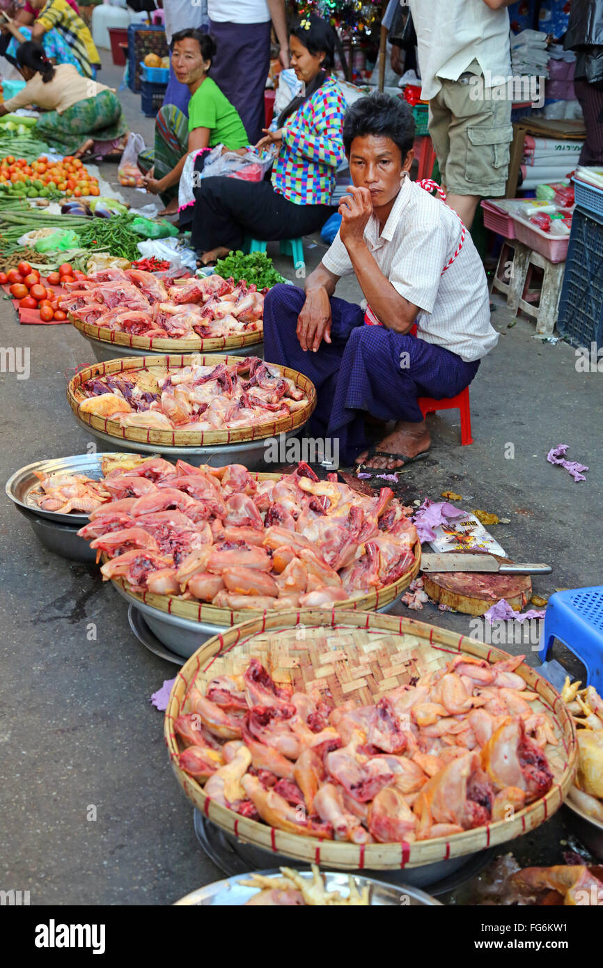 Man selling chicken in a street market, Yangon, Myanmar Stock Photo