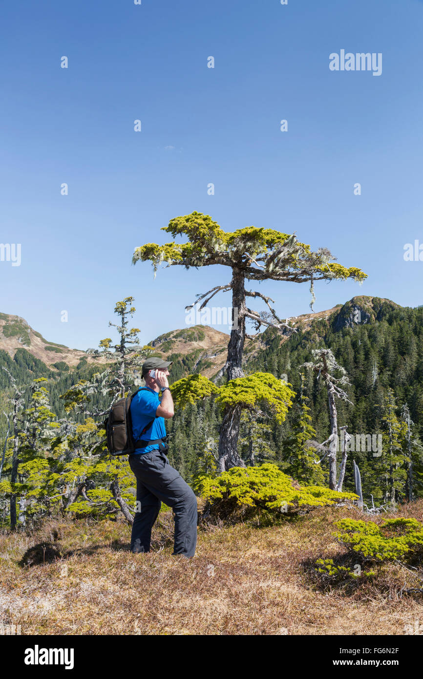 A man hikes along Gavin Hill Ridge on a clear day, Sitka, Southeast ...