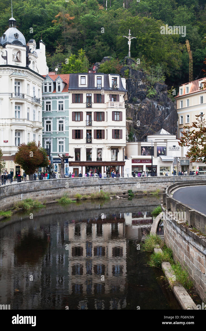 Statue of Christ on the cross above town and river; Karlova Vary, Czech Republic Stock Photo