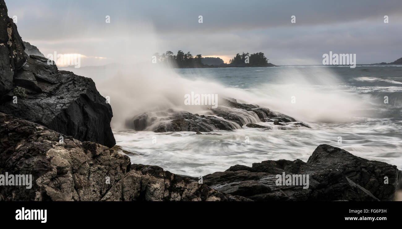 Mist in the air as waves crash against the rocky shore; Tofino, British Columbia, Canada Stock Photo