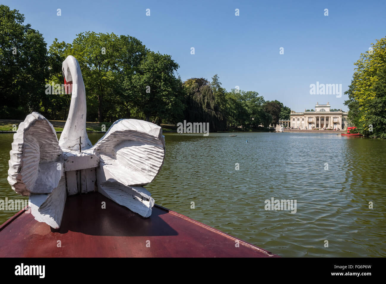 swan figure on the gondola boat and  Palace on the Water in Lazienki Krolewskie (Royal Baths Park) in Warsaw, Poland Stock Photo