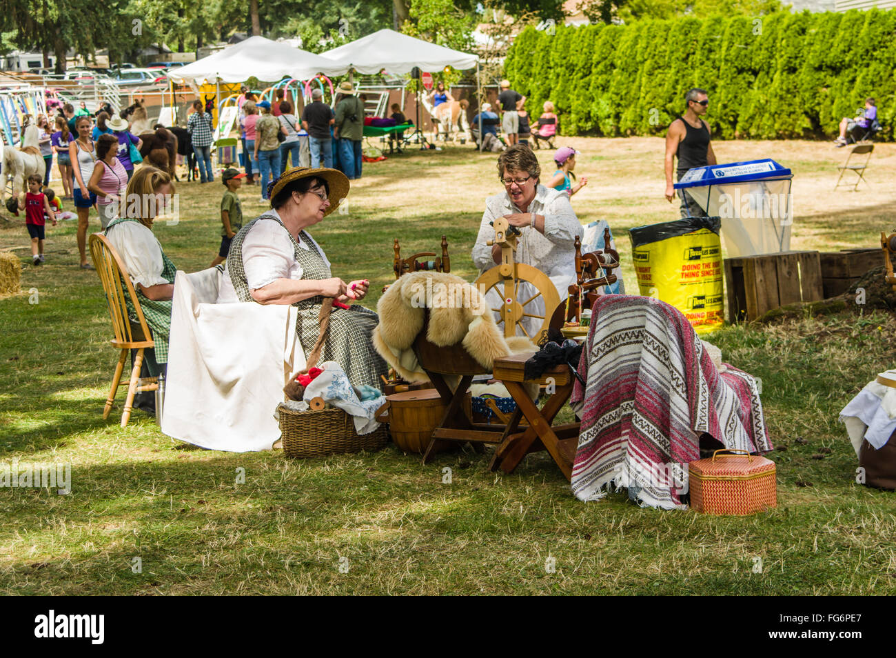 Spinners in vintage costume spinning yarn from wool at the Clackamas