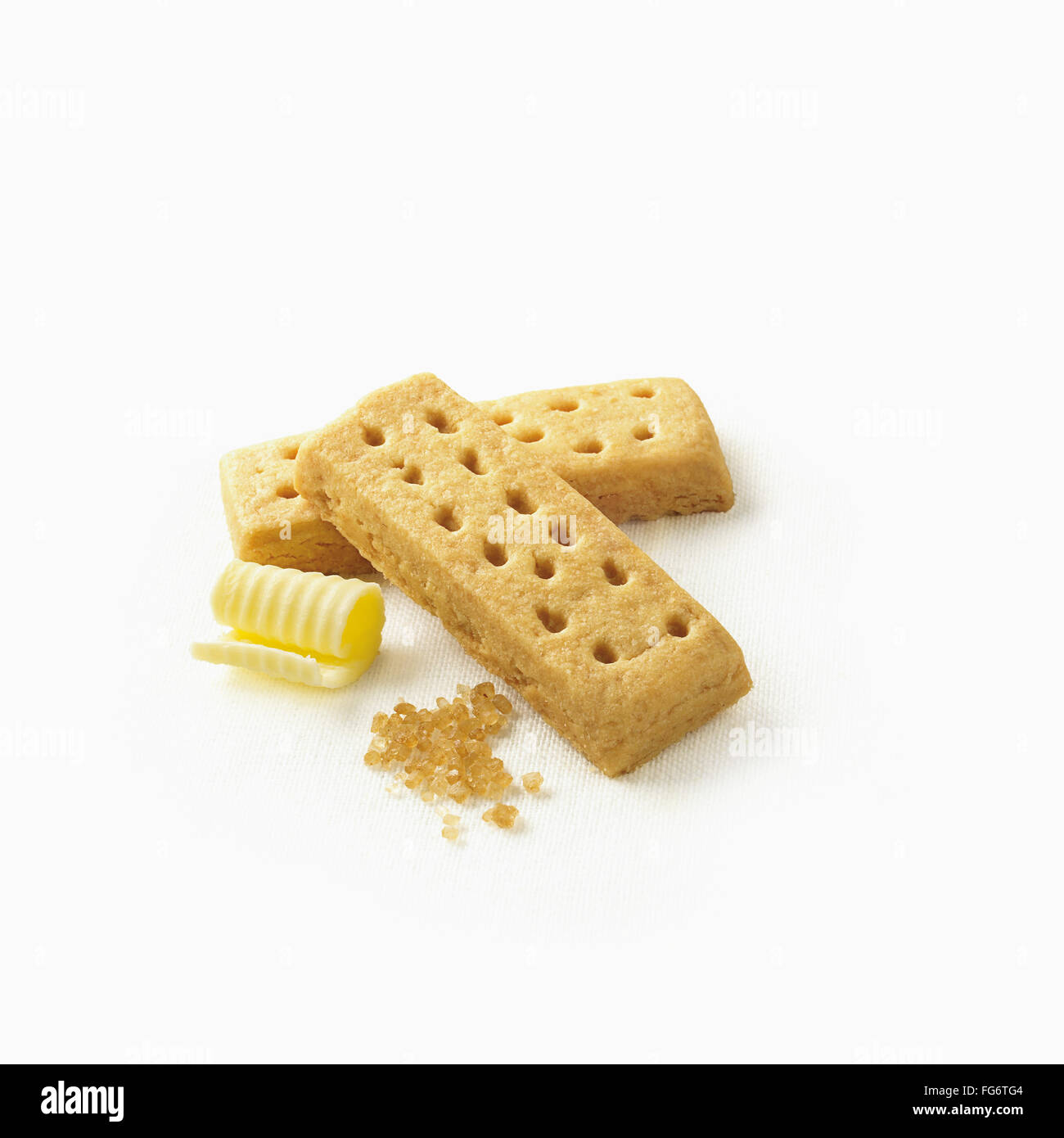 Cookies with curled butter and sugar crystals on a white background