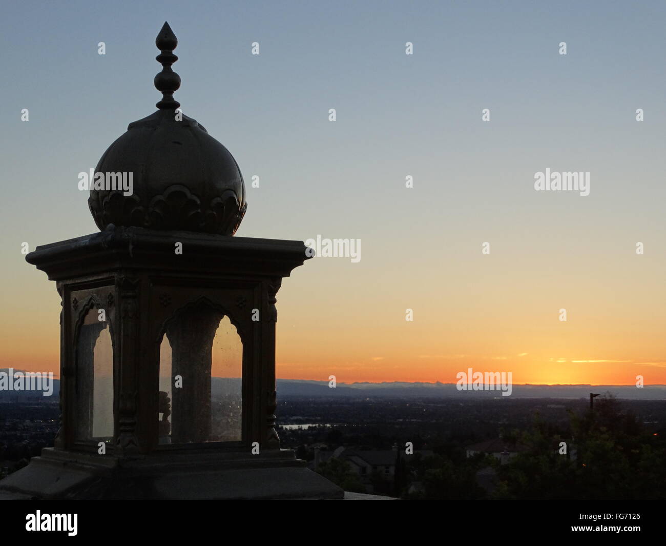 Sunset view of San Jose city and Bay with orange skyline, view from Sikh Gurdwara atop hill Stock Photo