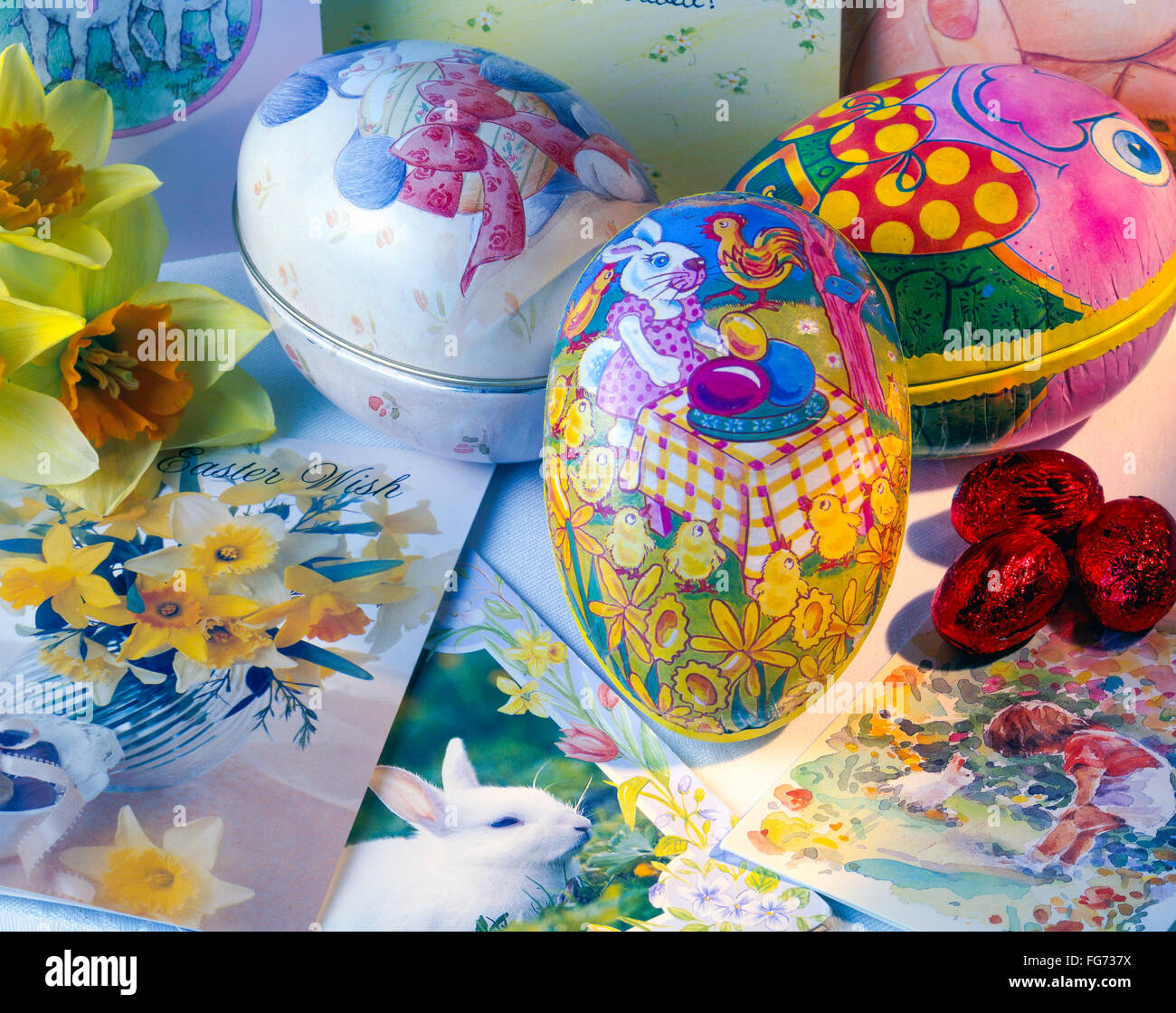 Easter eggs, cards and daffodils in studio setting. Stock Photo