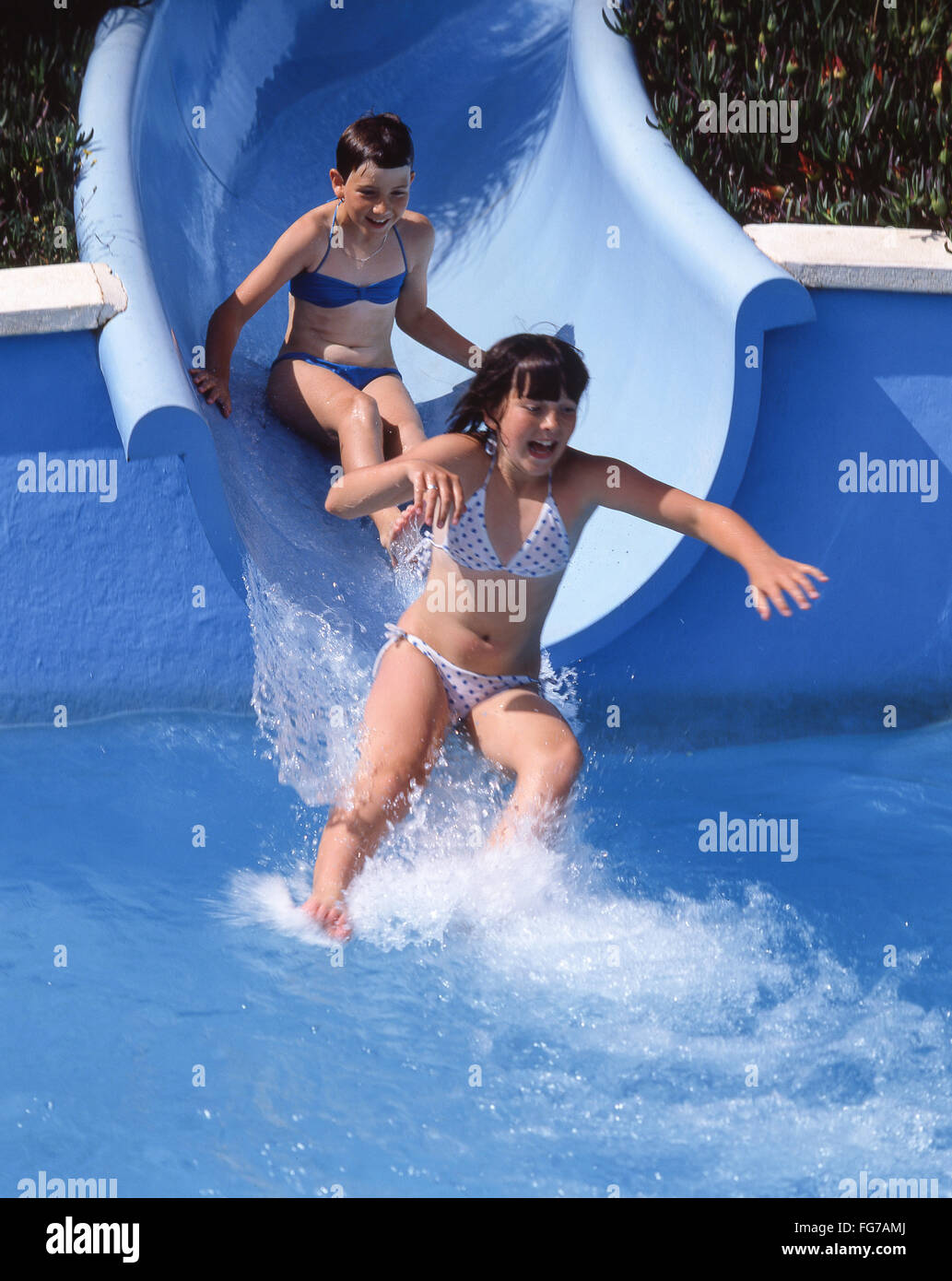 Young girls on waterslide, Alcudia Waterpark, Alcudia, Majorca (Mallorca), Balearic Islands, Republic of Spain Stock Photo