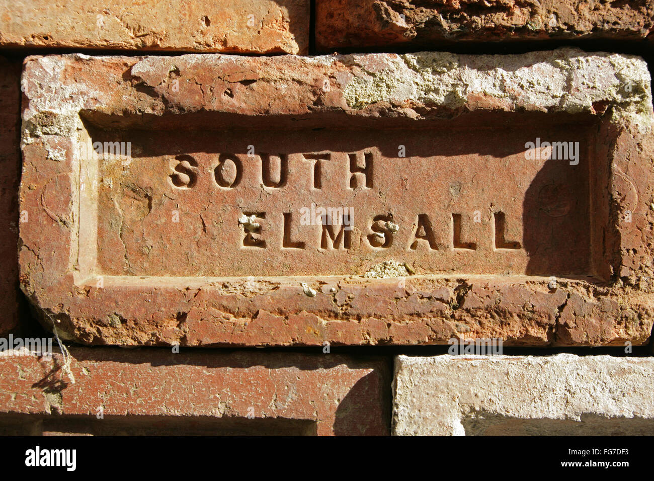 Old brick with the brickwork's mark "South Elmsall" imprinted into the