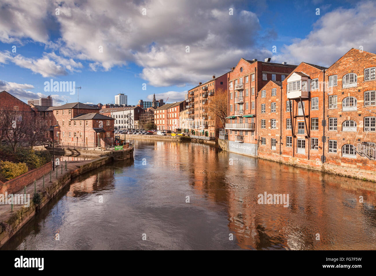 The River Aire in the centre of Leeds, West Yorkshire, England, UK, with apartment buildings on either side, some converted ware Stock Photo