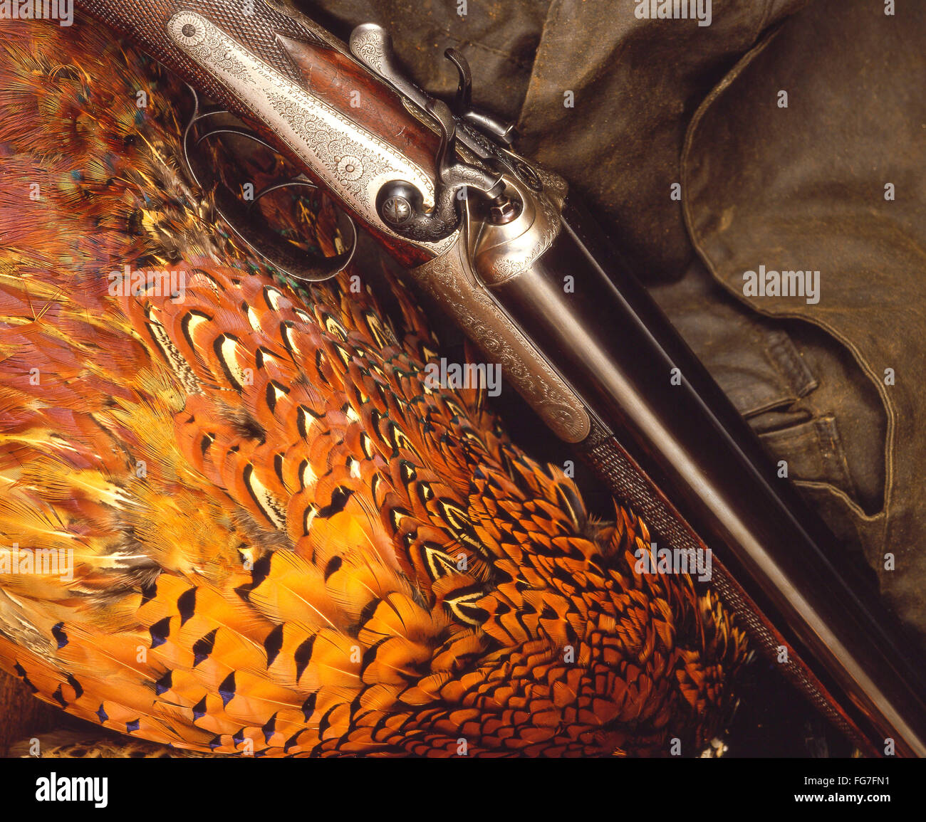 Antique shotgun with pheasant feathers and hunting jacket, London, England, United Kingdom Stock Photo