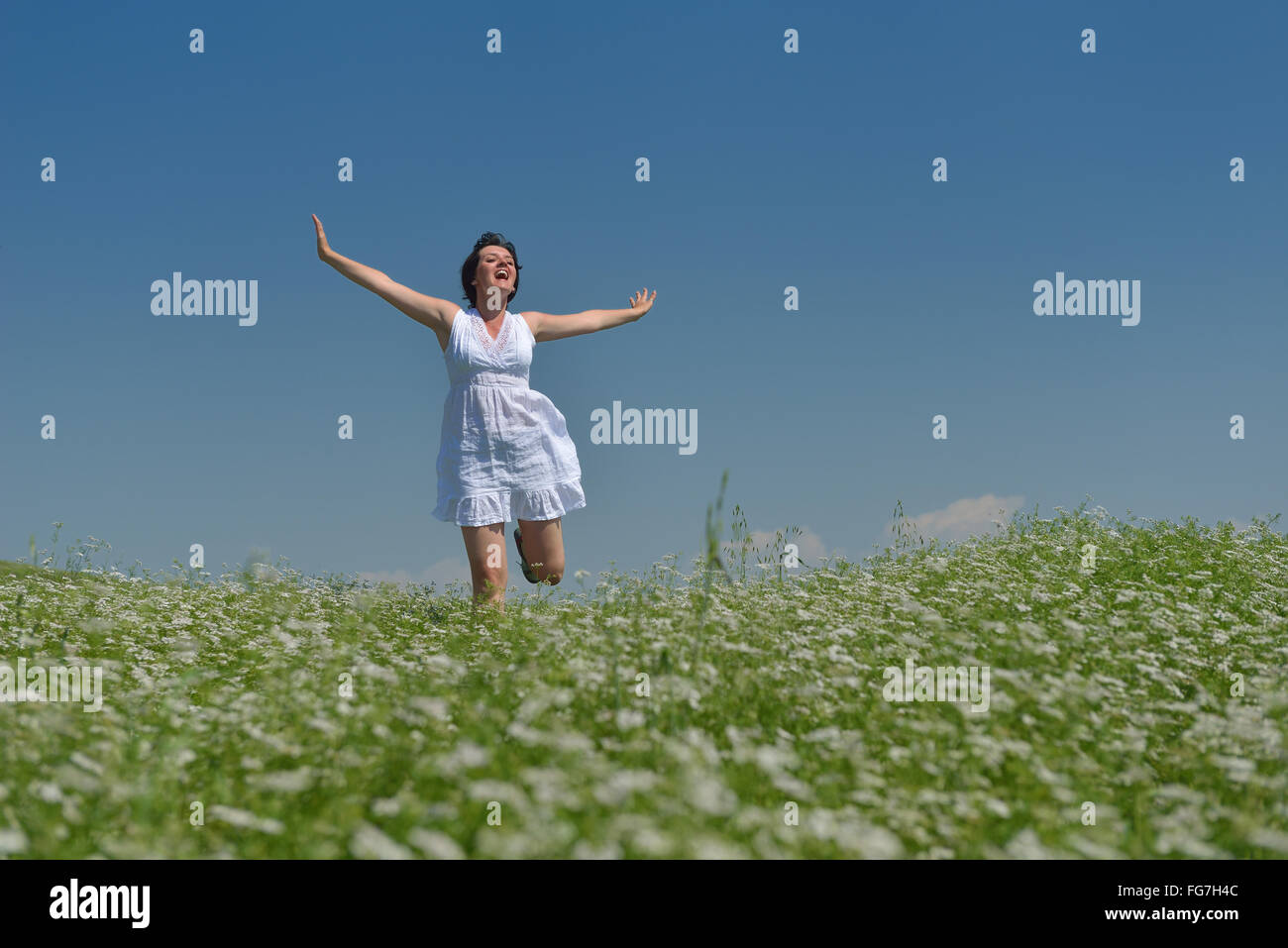 Young happy woman in green field Stock Photo - Alamy