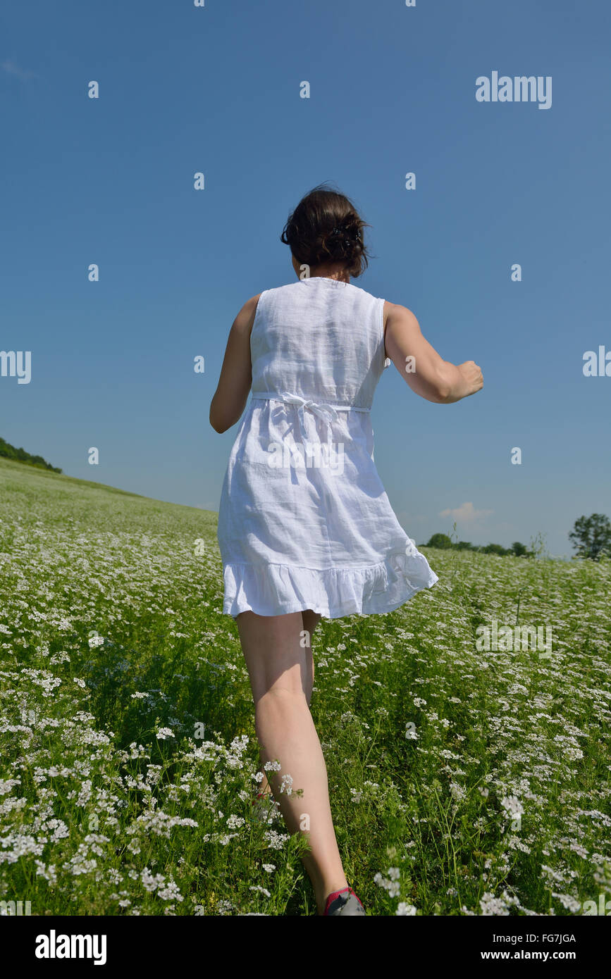 Young happy woman in green field Stock Photo - Alamy