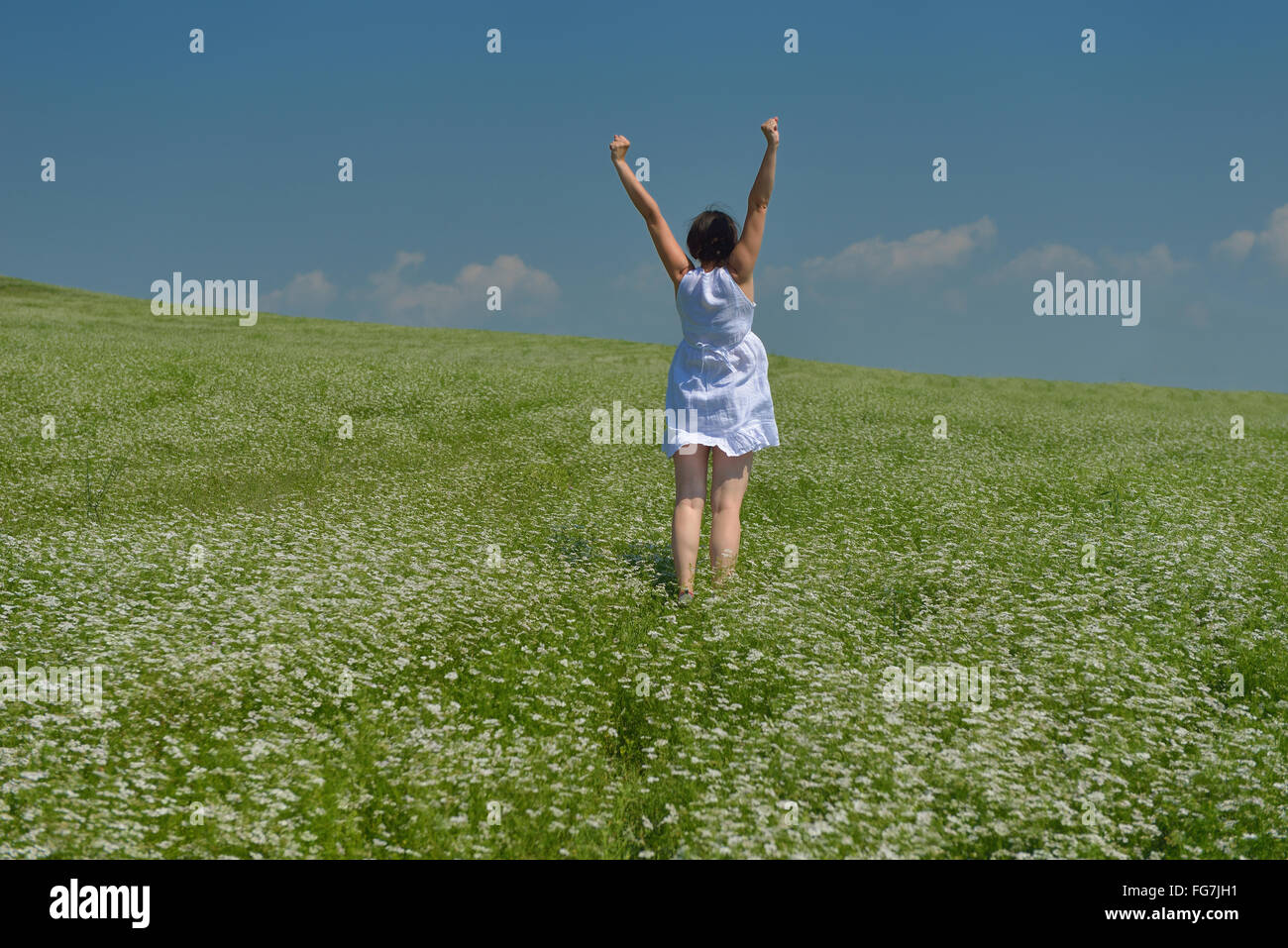 Young happy woman in green field Stock Photo - Alamy