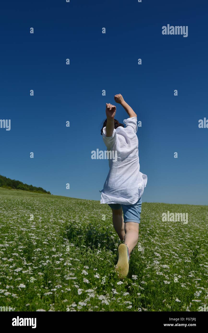 Young happy woman in green field Stock Photo - Alamy