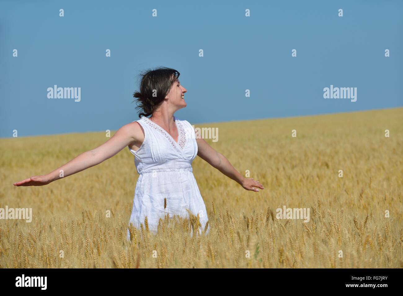 young woman in wheat field at summer Stock Photo - Alamy