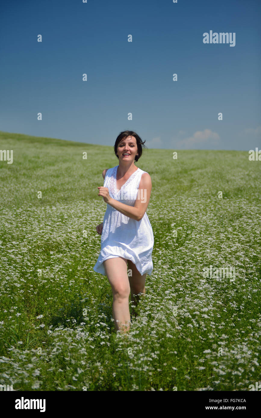 Young happy woman in green field Stock Photo - Alamy