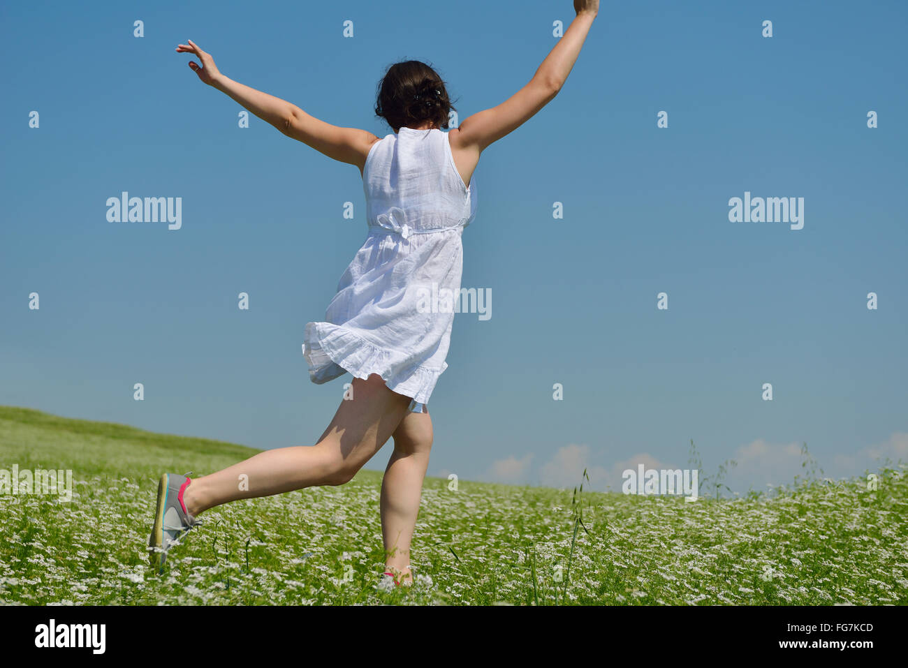 Young happy woman in green field Stock Photo - Alamy